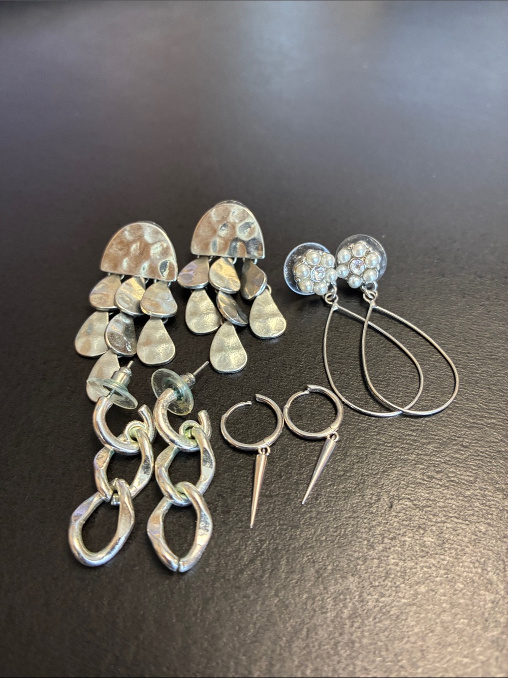 Bundle of silver tone dangle earrings
